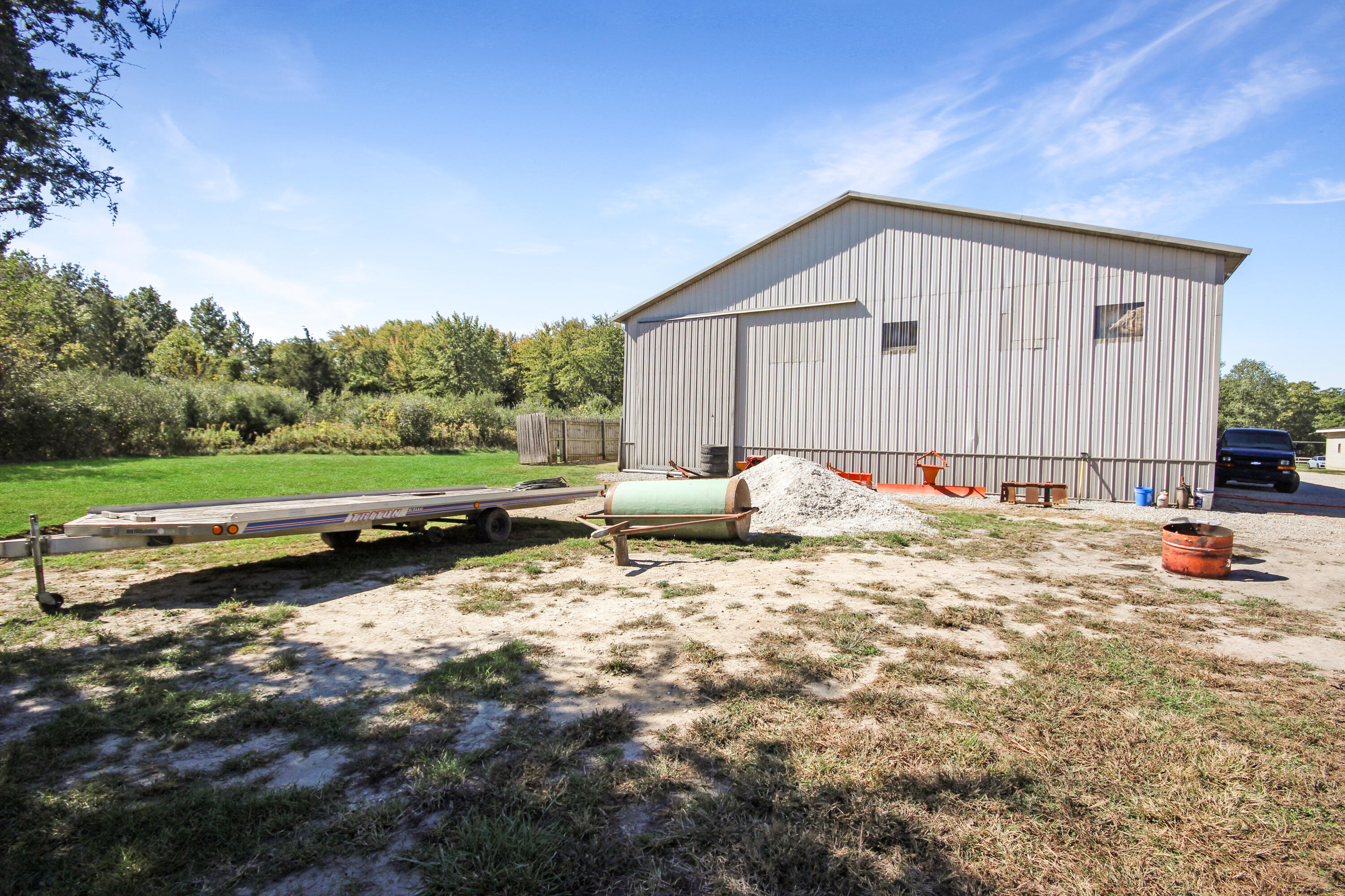 14615 Reeder Road Crown Point, IN 46307 - Photo 23 of 26 a backyard of a house with basket ball court tables and chairs