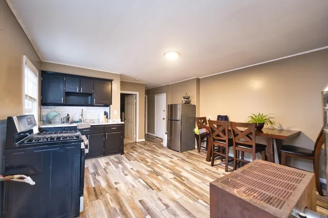 a kitchen with stainless steel appliances kitchen island granite countertop a sink and cabinets