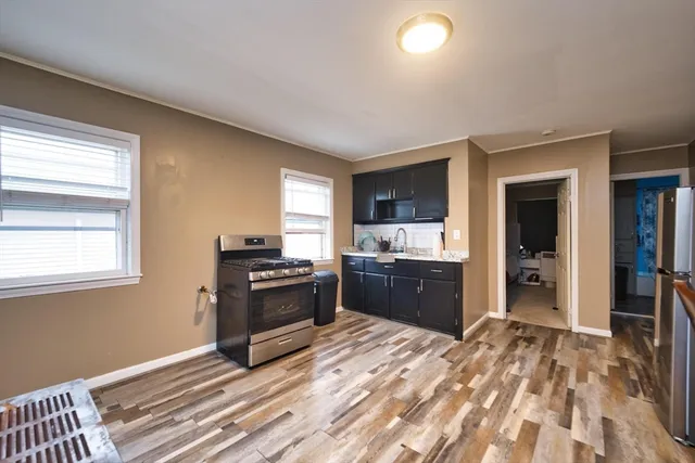 a kitchen with stainless steel appliances granite countertop a stove and a sink