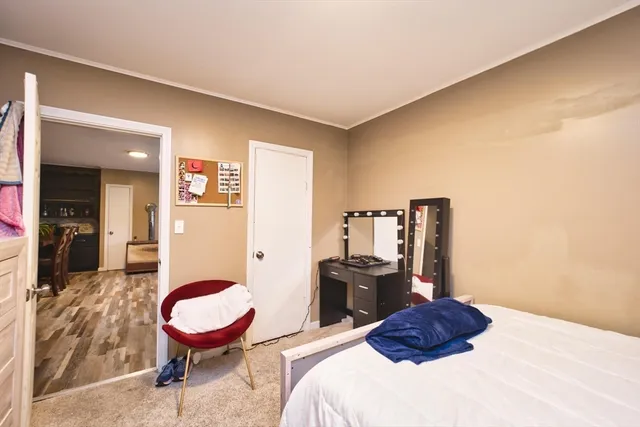 a bedroom with a bed and dresser