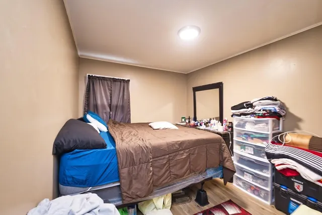 a bedroom with a bed and a painting on the wall