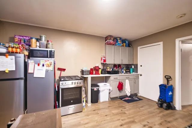 a utility room with fridge dryer and washer