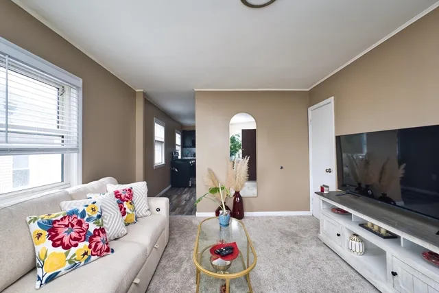 a living room with furniture and flat screen tv