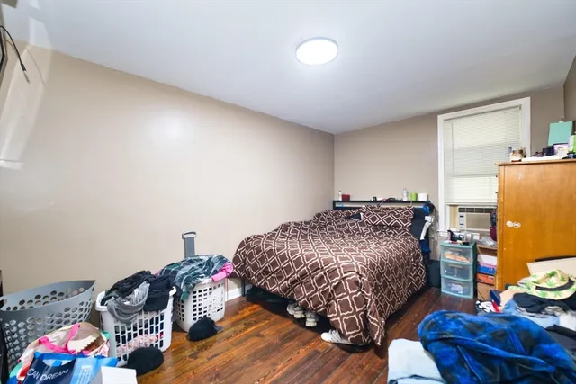 a bedroom with a bed and dresser