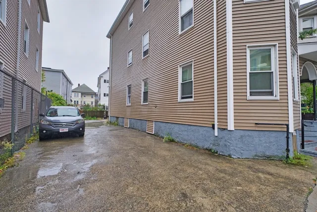 a view of a house with a yard and sitting area