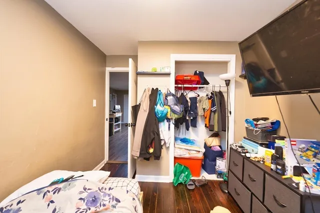 a bedroom with a bed and a closet