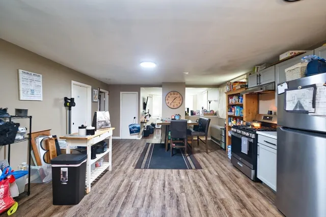 a living room with fireplace furniture and a wooden floor