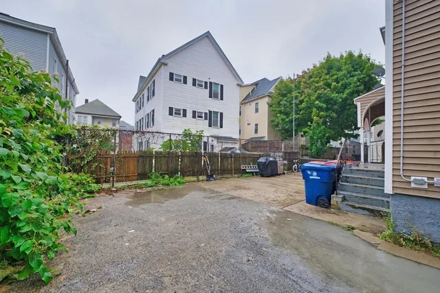 a view of a patio with table and chairs and potted plants
