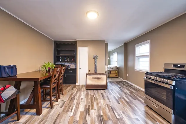 a dining room with furniture and wooden floor