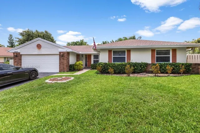 a view of a house with yard and a garden