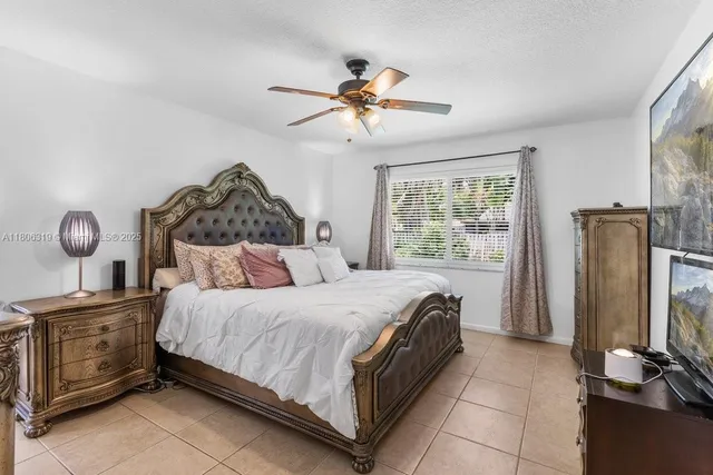 a bedroom with a bed dresser and a window