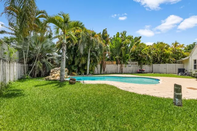 a view of a swimming pool with a yard