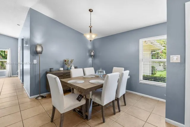 a dining room with furniture and window