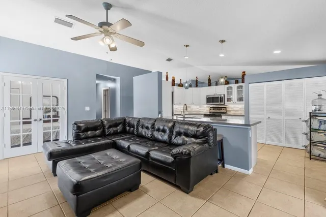 a living room with furniture and kitchen view