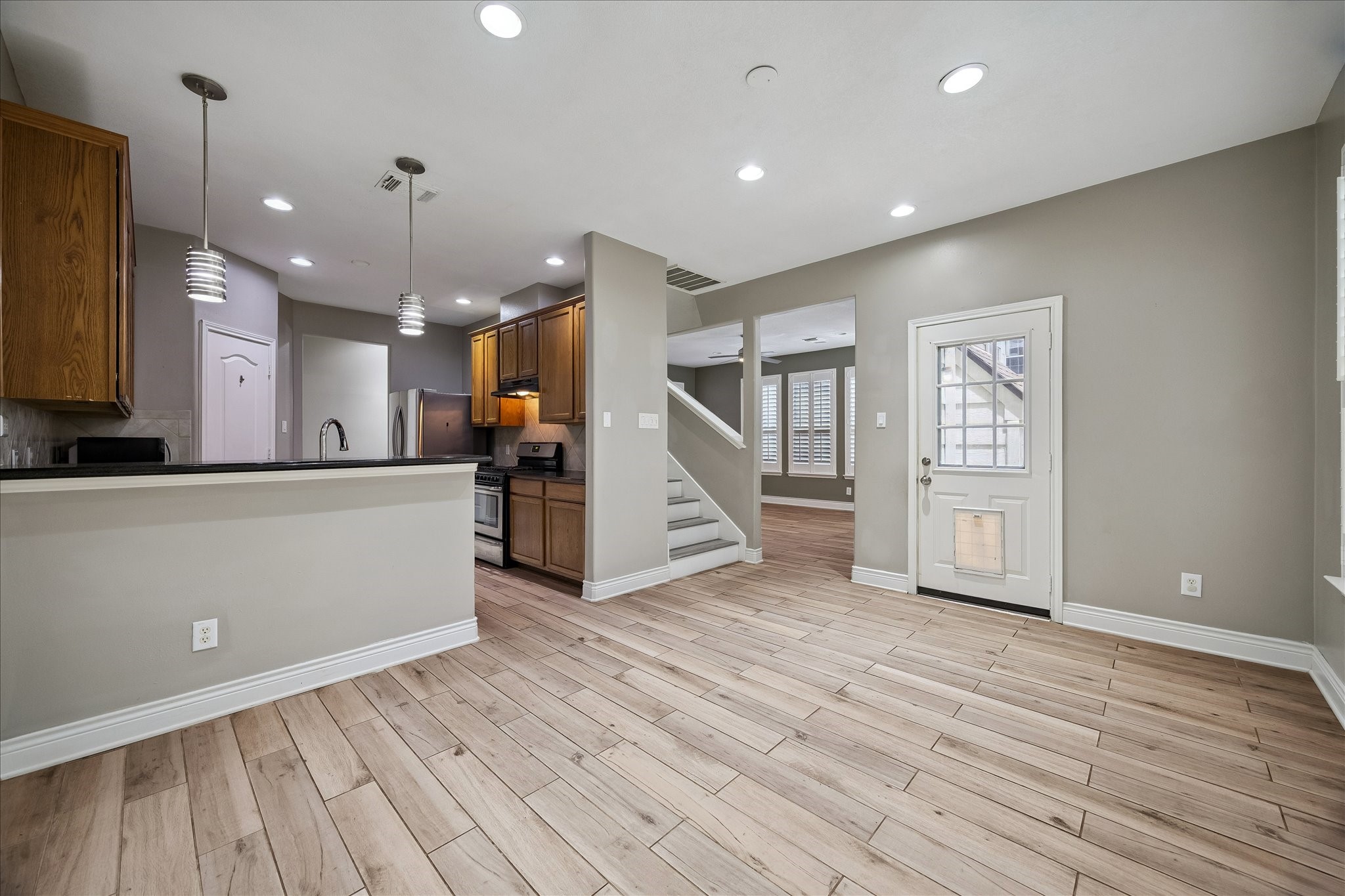 7403 Hollister Ridge Houston, TX 77040 - Photo 5 of 12 a view of a kitchen with wooden floor and a refrigerator
