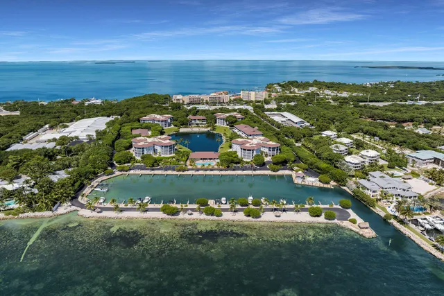 a view of a lake with a table and chairs