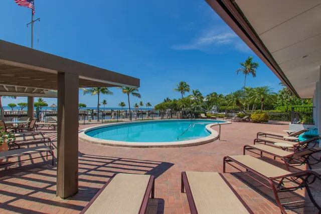 a view of a livingroom with furniture and floor to ceiling window