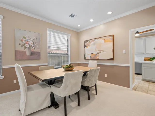 a view of a dining room with furniture and window