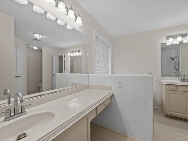 a bathroom with a sink a light fixture and a mirror