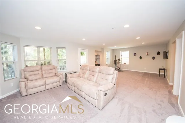 a living room with furniture white walls and white walls