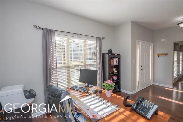 a living room with furniture and wooden floor