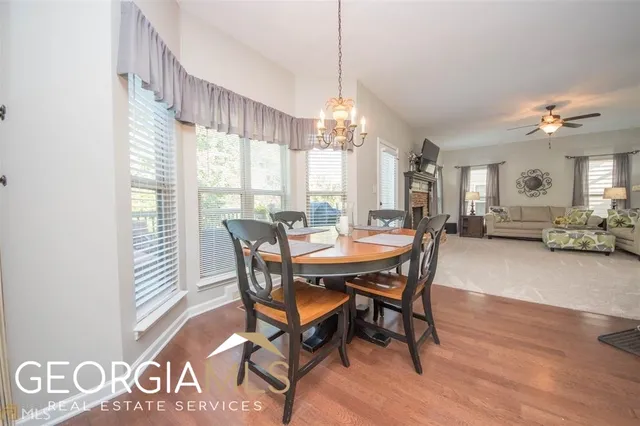 a view of a dining room with furniture window and wooden floor