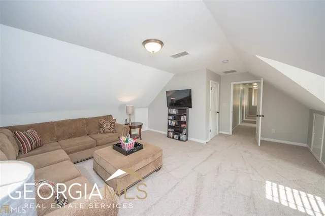 a living room with furniture and white walls