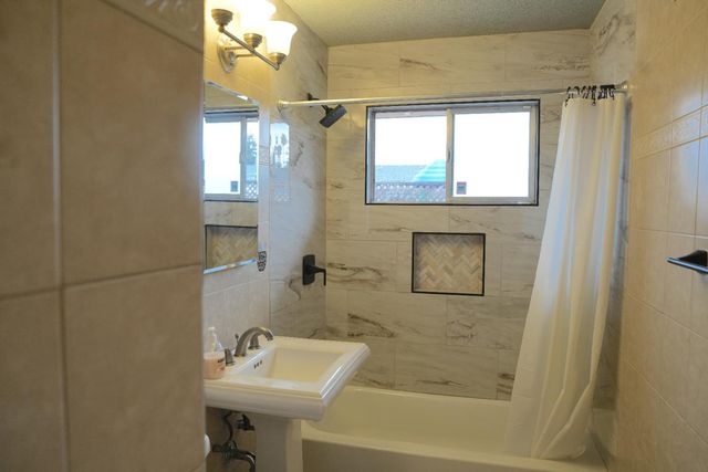 a bathroom with a sink a mirror and a shower