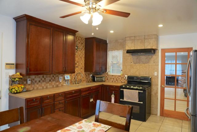 a kitchen with a sink cabinets and window
