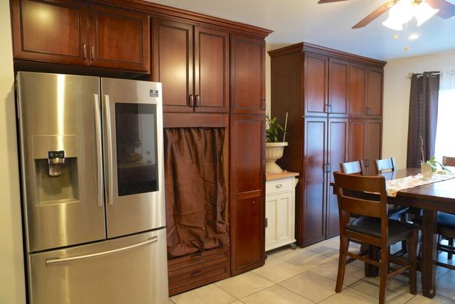 a kitchen with stainless steel appliances granite countertop a refrigerator and cabinets