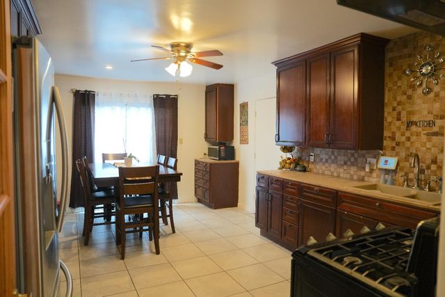 a kitchen with a table and chairs