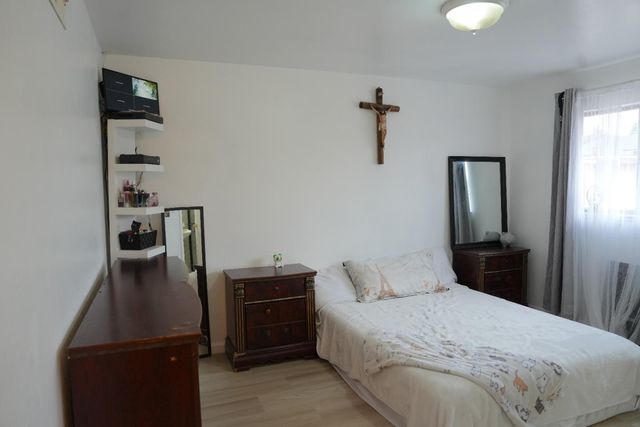 a bedroom with a bed and cabinets