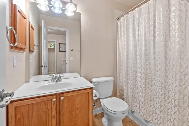 a bathroom with a toilet a sink and a mirror