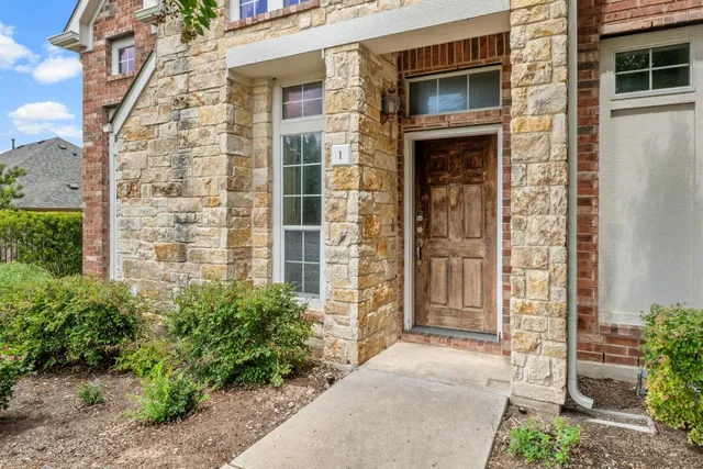 front view of a brick house with a large windows