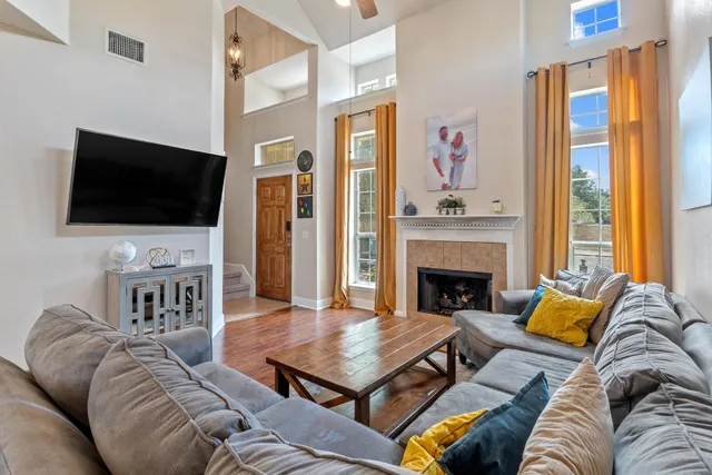 a living room with furniture a fireplace and a flat screen tv