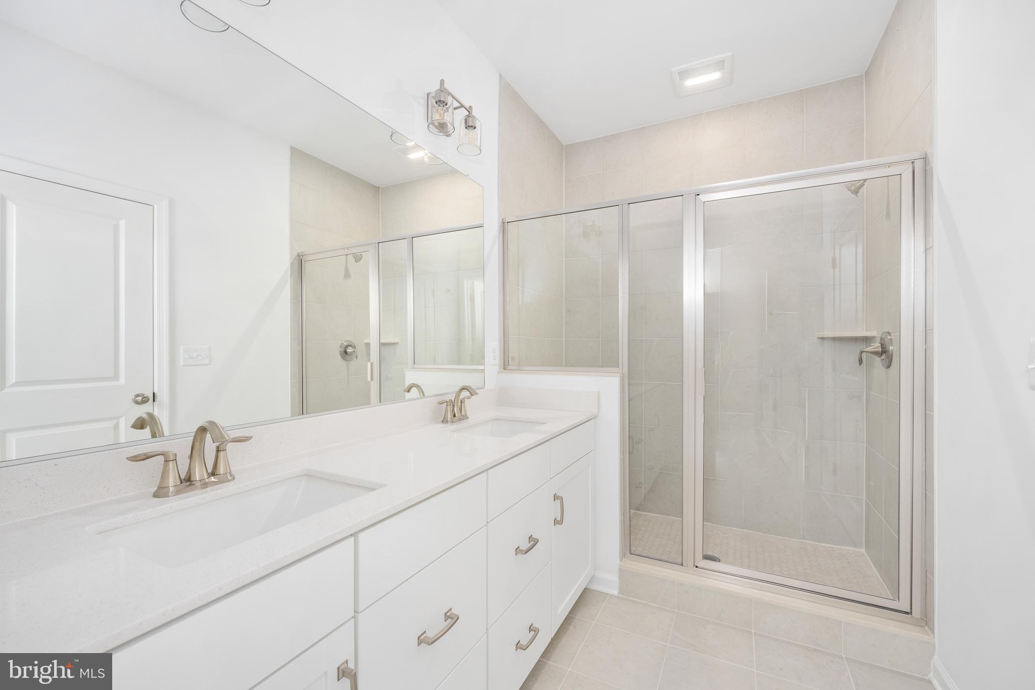 10157 Queens Way Manassas, VA 20110 - Photo 19 of 27 a bathroom with a double vanity sink mirror and shower