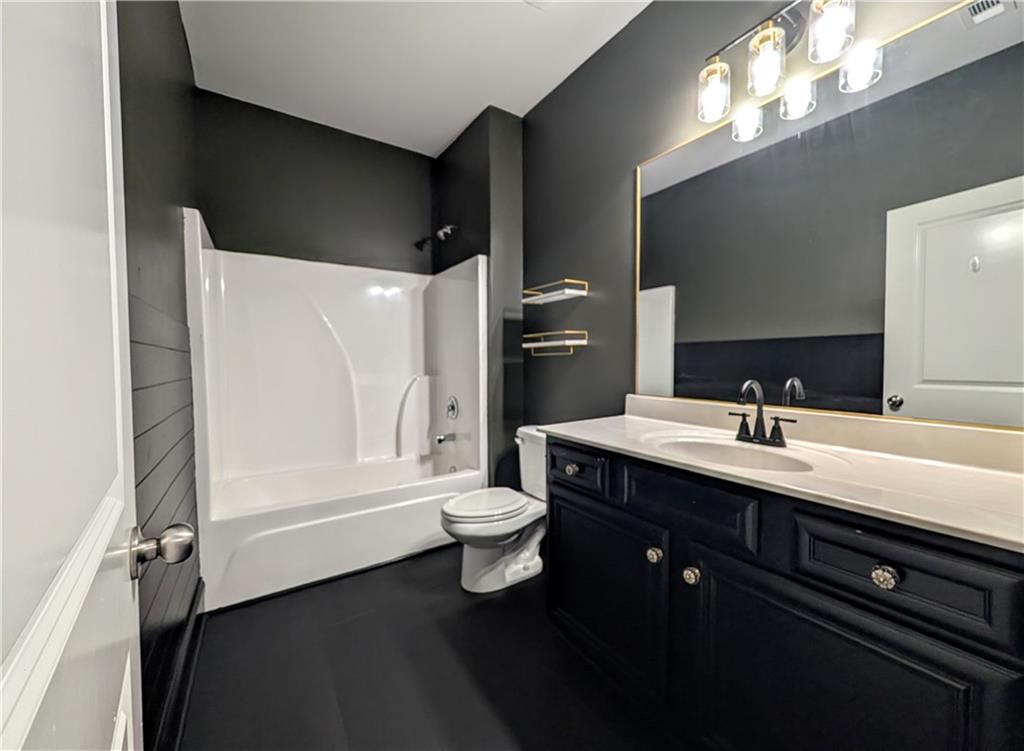 5250 Whisper Point Boulevard Cumming, GA 30028 - Photo 25 of 55 a bathroom with a double vanity sink and a toilet