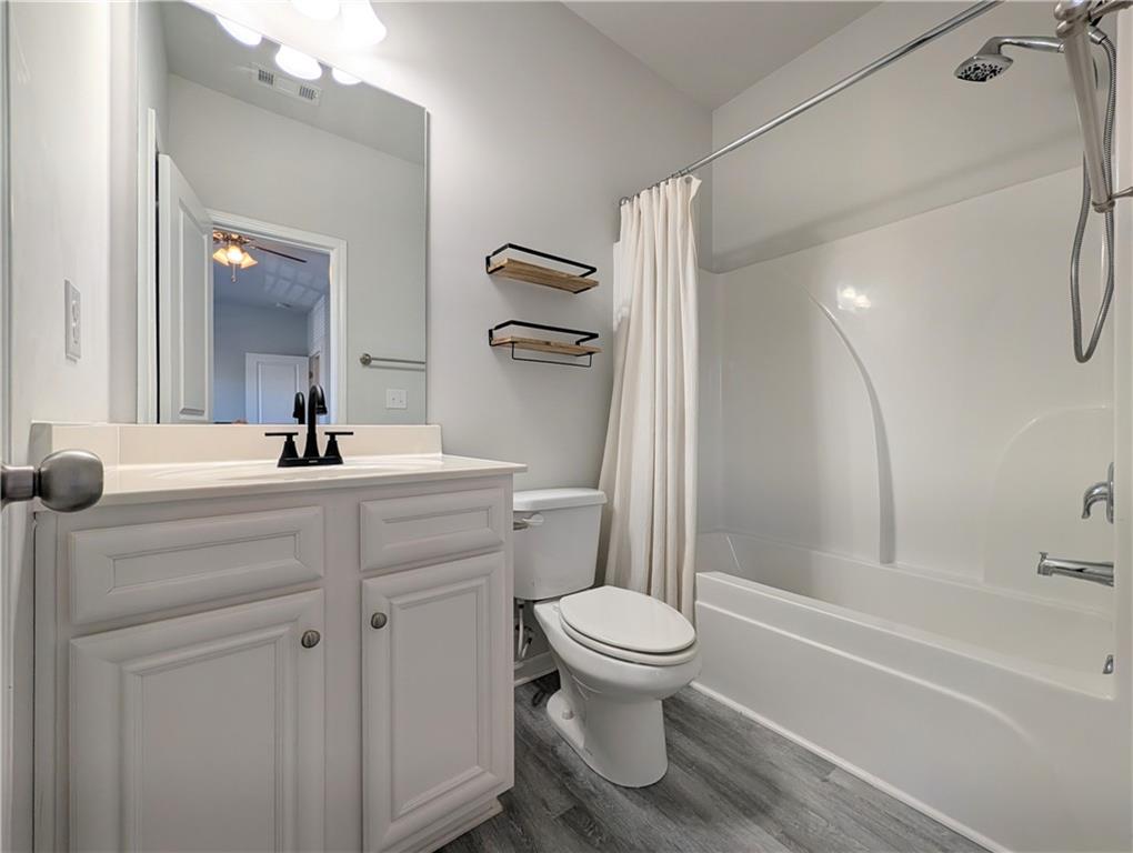 5250 Whisper Point Boulevard Cumming, GA 30028 - Photo 46 of 55 a bathroom with a sink toilet and shower