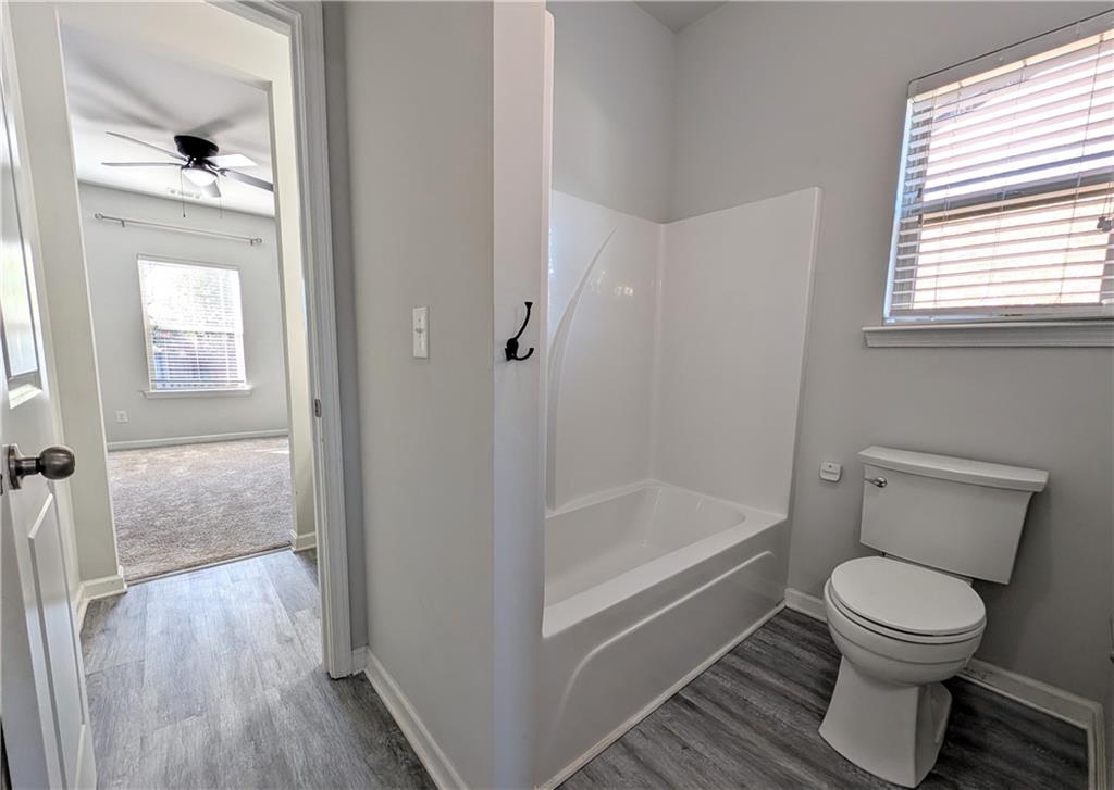 5250 Whisper Point Boulevard Cumming, GA 30028 - Photo 51 of 55 a bathroom with a toilet and a bathtub