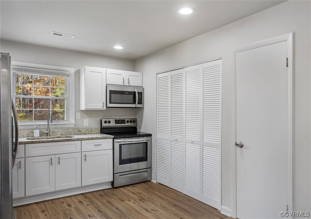 13506 Verdon Road Ruther Glen, VA 22546 - Photo 13 of 27 a kitchen with stainless steel appliances granite countertop a stove a sink and a microwave