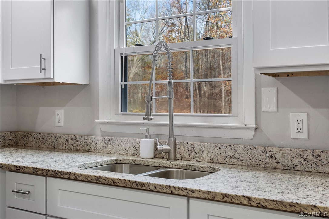 13506 Verdon Road Ruther Glen, VA 22546 - Photo 15 of 27 a kitchen with granite countertop a sink and cabinets