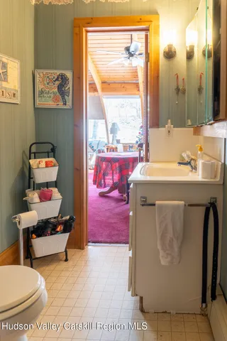 a living room with furniture a window and gym equipment