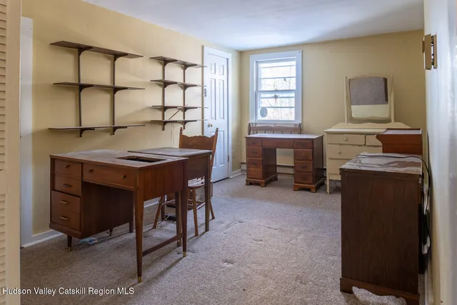 a room with furniture closet and a window