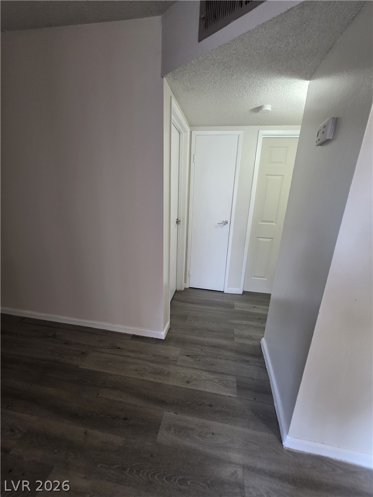 1075 East Desert Inn Road, Unit 5 Las Vegas, NV 89109 - Photo 11 of 12 Clean lines and durable laminate flooring enhance this functional interior hallway.