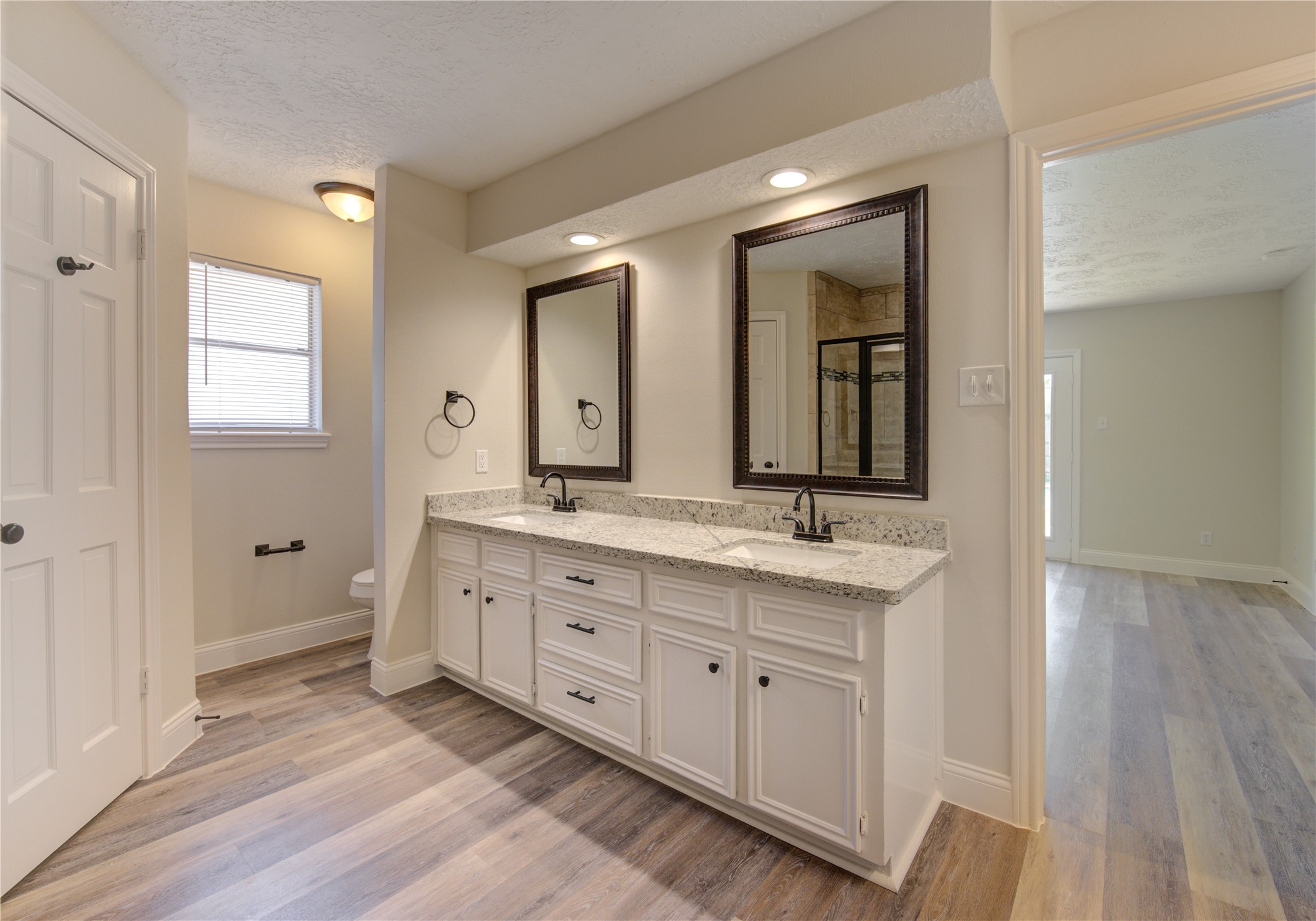 9115 Taidswood Drive Spring, TX 77379 - Photo 25 of 45 The primary bath has two rectangle sinks, granite counters and bronze hardware.