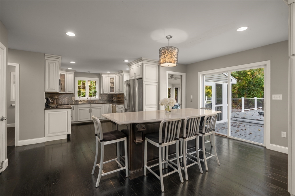 16 Autumn Woods Road Salem, NH 03079 - Photo 13 of 29 a dining area with stainless steel appliances a dining table chairs and wooden floor