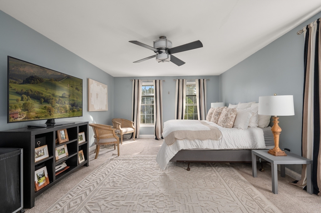 16 Autumn Woods Road Salem, NH 03079 - Photo 19 of 29 a bedroom with furniture a bed and a flat screen tv