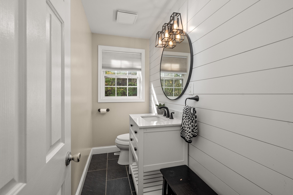 16 Autumn Woods Road Salem, NH 03079 - Photo 27 of 29 a bathroom with a toilet a sink and mirror