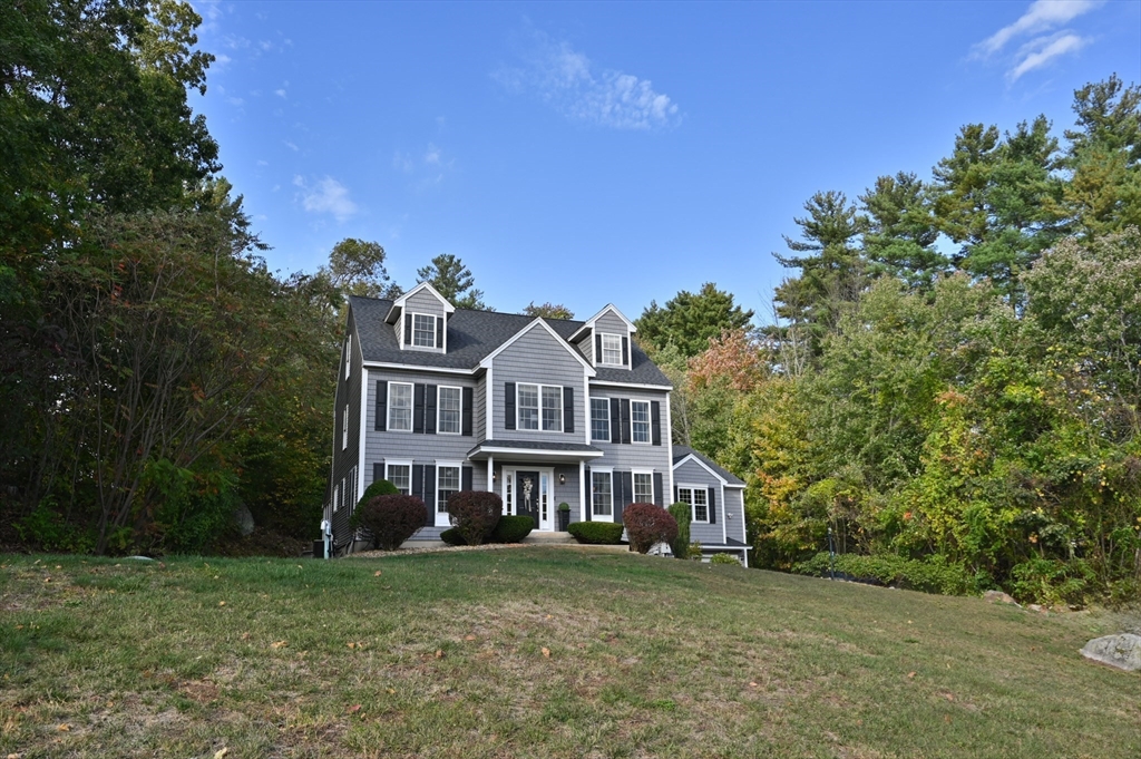 16 Autumn Woods Road Salem, NH 03079 - Photo 3 of 29 a front view of a house with a garden
