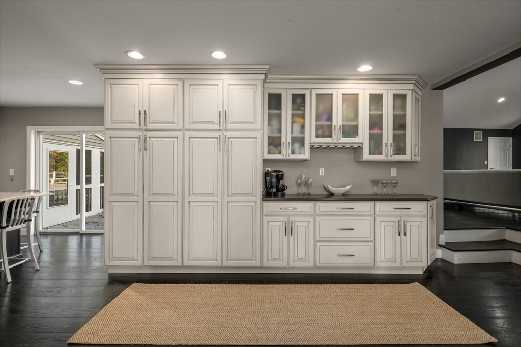 16 Autumn Woods Road Salem, NH 03079 - Photo 10 of 29 a kitchen with granite countertop white cabinets and white appliances